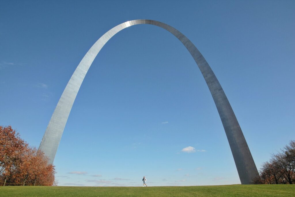 The St. Louis Arch stands against a backdrop of pure blue sky.